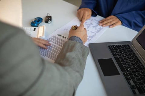 Photo of Consumer Signing Auto Loan Contract Photo of Consumer Signing Auto Loan Contract