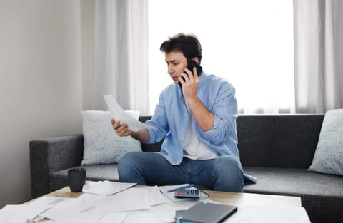Photo of Man on Phone Calling Utility Company About Bill Photo of Man on Phone Calling Utility Company About Bill