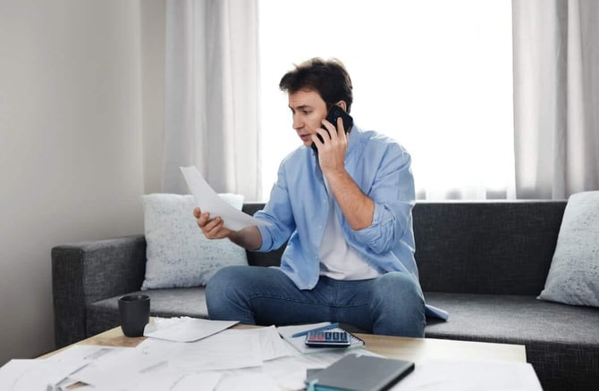 Photo of Man on Phone Calling Utility Company About Bill Photo of Man on Phone Calling Utility Company About Bill
