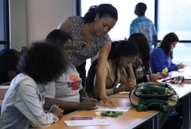 An image of a Credit Abuse Resistance Education (CARE) volunteer helping students