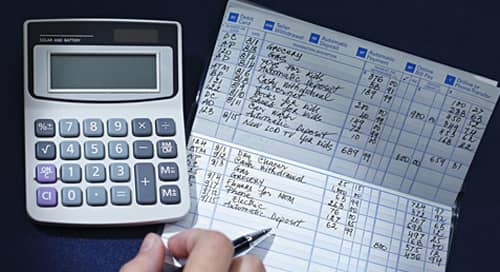 Image of a checkbook and calculator. 