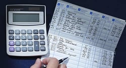 Image of a checkbook and calculator. 