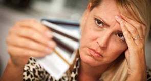 Image of a woman looking frustrated with her credit cards. Image of a woman looking frustrated with her credit cards.