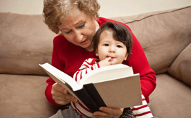 Photo of a Caregiver Reading to a Child