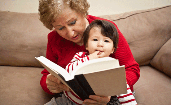 Photo of a Caregiver Reading to a Child Photo of a Caregiver Reading to a Child