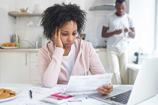 Concerned Woman Looking at Bills Concerned Woman Looking at Bills